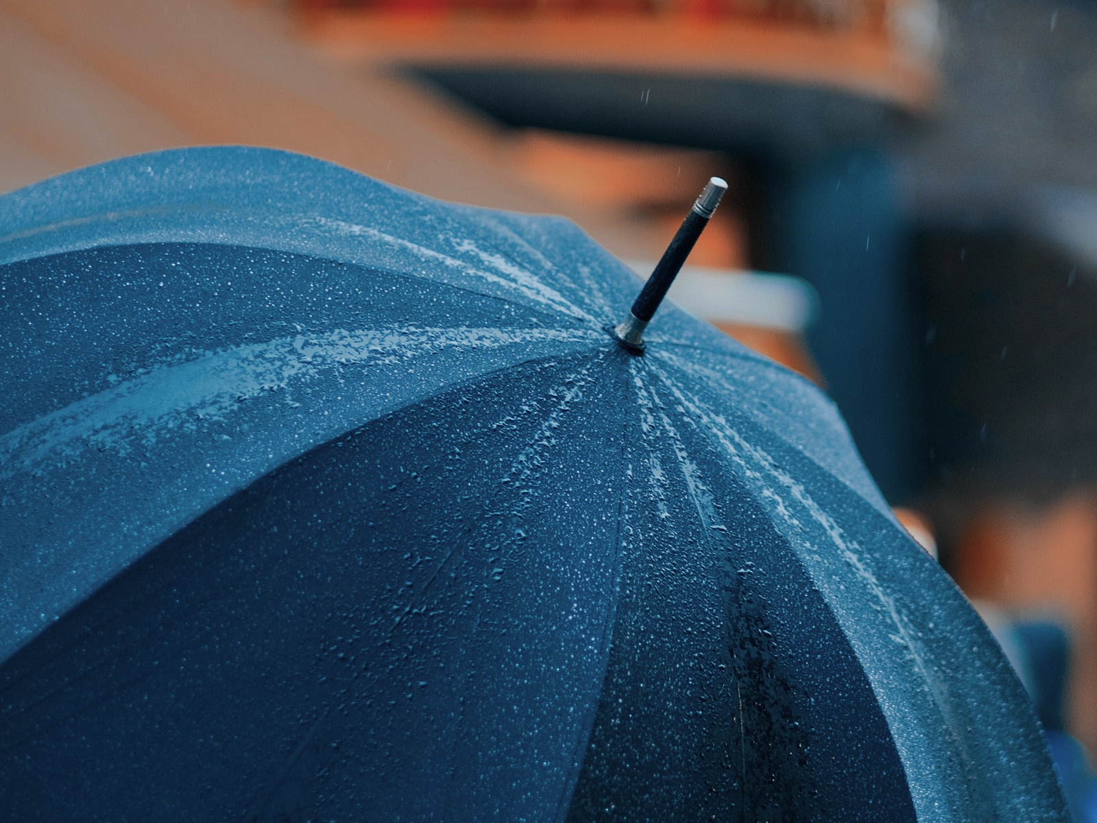 A traditional gentleman's umbrella with a beautifully shaped wooden handle, celebrating the history, ingenuity and enduring craftsmanship of one of Britain's most familiar accessories.